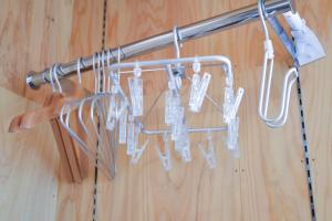 a bunch of utensils hanging from a metal rack at 安全第一 客室　コンテナハウス in Nishiawakura