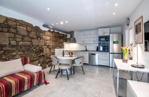 a kitchen and living room with a table and a couch at Relax House Rosemary in Draga Bašćanska