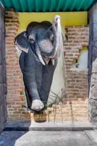 a painting of an elephant on the side of a wall at Treetop Resort By Scenery Villas in Dharga Town