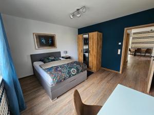 Un dormitorio con una cama y una mesa. en Schölerberg Appartement l ruhige Lage l nah an Zoo, en Osnabrück