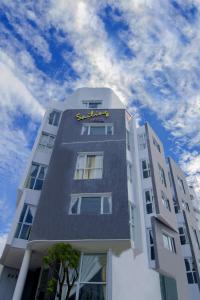 a tall building with a clock on top of it at Sailing Hotel Phú Quốc in Phu Quoc