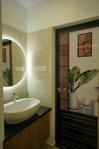 a bathroom with a sink and a mirror at Home stay - Near Cochin Airport in Angamali