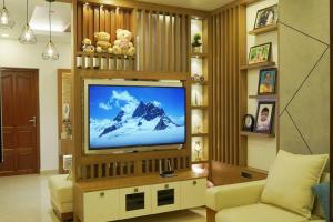 a living room with a large flat screen tv at Home stay - Near Cochin Airport in Angamali