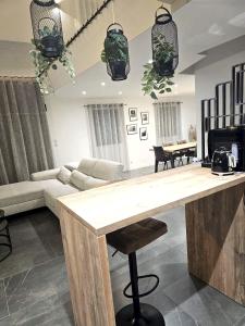 a kitchen and living room with a wooden counter top at Villa de 4 chambres avec piscine privee sauna et jardin clos a Riom in Riom