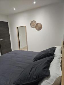 a bedroom with a bed with a pillow and a mirror at Villa de 4 chambres avec piscine privee sauna et jardin clos a Riom in Riom