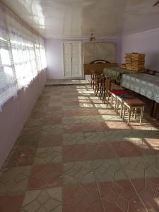 an empty room with chairs and a table and a window at Ismayilli Halal Family Guest House, Ailəvi Bag Evi, Vacation House in İsmayıllı