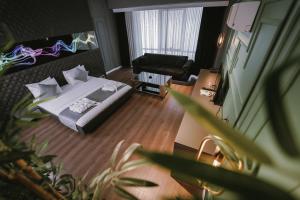 a hotel room with a bed and a couch at ENNA SUIT HOTEL in Nilüfer