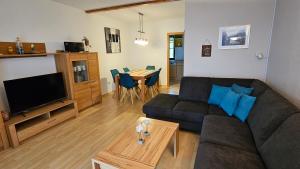 a living room with a couch and a table at Lechbruck am See Feriendorf Hochbergle Haus 142 - Lechseeblick in Lechbruck