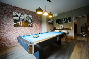 a pool table in a room with a brick wall at Hotel Hirschberg in Hirschberg an der Bergstraße