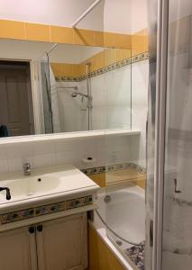 a bathroom with a sink and a shower and a tub at Appartement région de St-Tropez in Grimaud