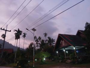 une station-service avec des palmiers la nuit dans l'établissement Bamboo House, à Khao Sok