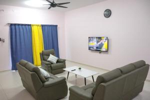 a living room with two chairs and a table at JOY SITIAWAN HOMESTAY in Sitiawan