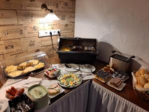 a buffet with many different types of food on a table at Hotel Angerland Garni in Ratingen