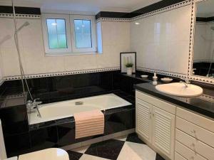 a bathroom with a tub and a sink at La Costana - San Cucao de Llanera in Agüera +30 photos