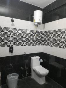 a black and white bathroom with a toilet at Aagaman Woods Homestay in Shimla