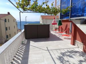 een balkon met een tafel en uitzicht op de oceaan bij Sea view Holiday Home in Okrug Gornji near Bocici Beach in Trogir