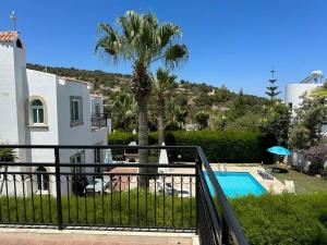 a villa with a palm tree and a swimming pool at Villa Chrysanthemum in Neo Chorio