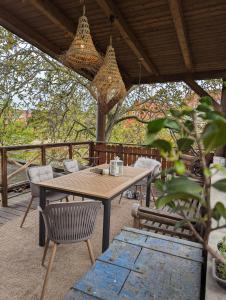 a wooden table and chairs on a patio at Spechtnest in Naumburg