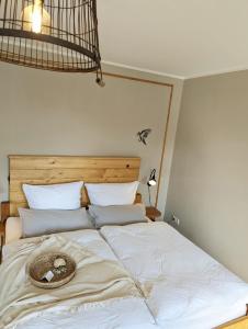 a bedroom with a bed with a hat on it at Spechtnest in Naumburg