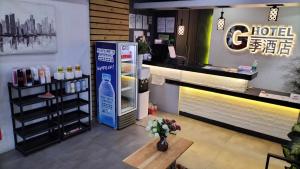 a coffee shop with a refrigerator and a table at G Hotel in Dauis