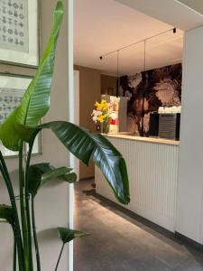 a large green plant in a room with a counter at Hotel Clodia - Adults Only in Sirmione