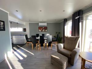 a living room with a dining room table and chairs at Polar Arctic Luxury House - Free parking in Tromsø