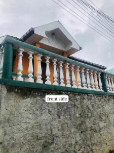 a balcony on a wall with a front side at Rizi Bungalow In Nuwara Eliya in Nuwara Eliya