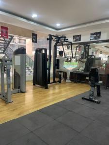 a gym with a man working out in a gym at Luxury 3 bedroom independent appartment in Ghaziabad