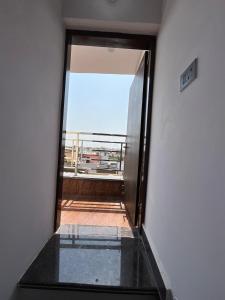 an empty room with a view of a balcony at Vinayak Homestay in Mathura