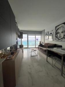a kitchen and living room with a view of the ocean at Renthas Torre Lugano in Benidorm