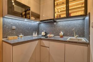 a kitchen with white cabinets and a sink at Apartments Elena in Budva