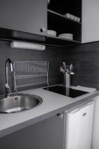 a kitchen with a sink and a counter top at Terracota - Cosi - Wifi - Parking - Terrasse in Saint-Orens-de-Gameville