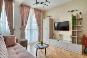 a living room with a couch and a tv at Apartments Elena in Budva