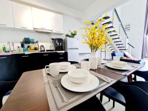 a kitchen with a wooden table with dishes on it at Garden Duplex Studio 7 Guest Old Klang Road Kuala Lumpur Mid Valley Pearl Point Bangsar Bangsar South Bukit Jalil Taman Desa ML in Kuala Lumpur