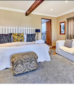 a large bedroom with two beds and a couch at Midrand Wild Goose Guest House B&B in Midrand