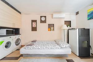 1 dormitorio con cama, lavadora y secadora en B48 Simplex - egyszinten, kényelmesen, en Törökbálint