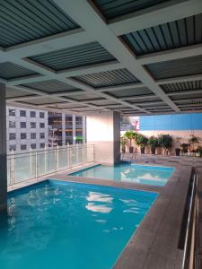 a swimming pool on top of a building at ADB Tower - Loft Unit Hotel Vibe in Manila