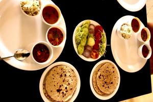 a table with plates of food and bowls of dips at Desert Life safari camp in Sām