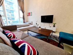 a living room with a couch and a tv at Garden Duplex Studio 7 Guest Old Klang Road Kuala Lumpur Mid Valley Pearl Point Bangsar Bangsar South Bukit Jalil Taman Desa ML in Kuala Lumpur