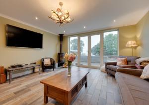 a living room with a couch and a table at Malt Hall in Llanrhidian