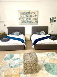 a bedroom with two beds and a rug at la Borghese in Rome