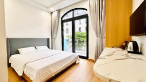 um quarto com 2 camas e uma grande janela em GOLDEN SEA HOTEL *** em Ðố Sơn