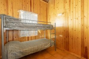 a bunk bed in a room with wooden walls at Bungalow Alós in Alós de Balaguer +19 photos