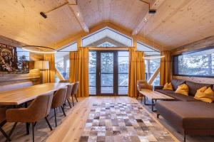 a living room with a couch and a table at Naturchalets Turracher Höhe by ALPS RESORTS in Turracher Hohe