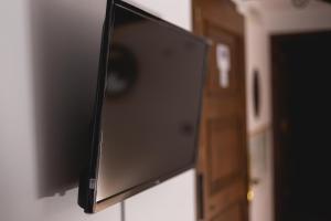a flat screen tv hanging on a wall at Hostal Corper Navalcarnero in Navalcarnero
