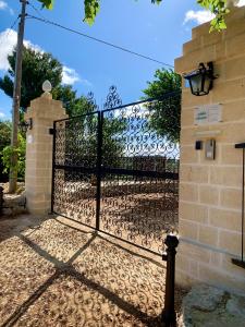 a gate with a wrought iron fence at Antica Masseria in Padresergio