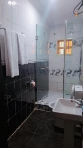 a bathroom with a shower and a toilet and a sink at Zek's Place in Lagos
