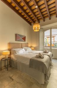 a bedroom with a large bed and two lamps at Casa Rental home Campana in Seville