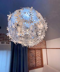 a large crystal chandelier hanging from a ceiling at Akira&chacha杉並区世田谷direct to shinjuku for 13 min 上北沢4分 近涉谷新宿 in Tokyo