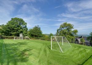 a soccer field with a net in the grass at 1 Derw Cottages in Trefeglwys